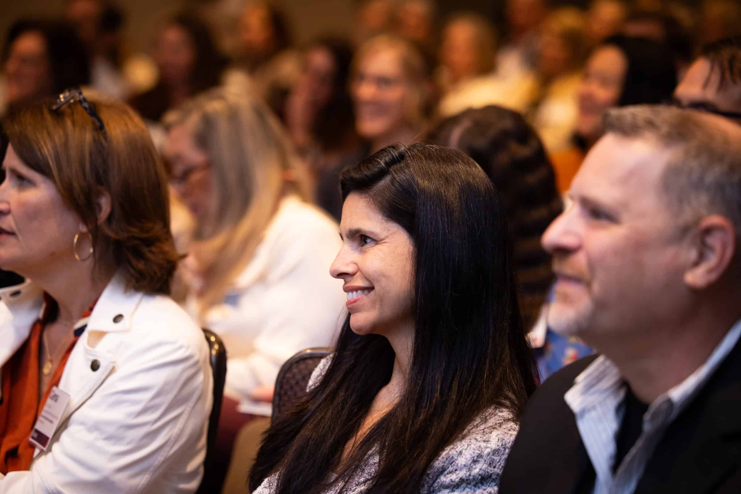 Smiling SAIS 2025 Annual Conference attendees listen during keynote session