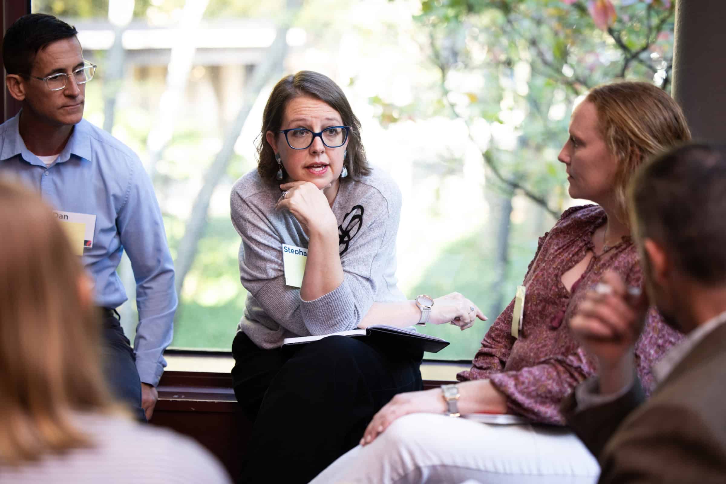 Engaged small group of adults discuss topics during annual conference breakout session